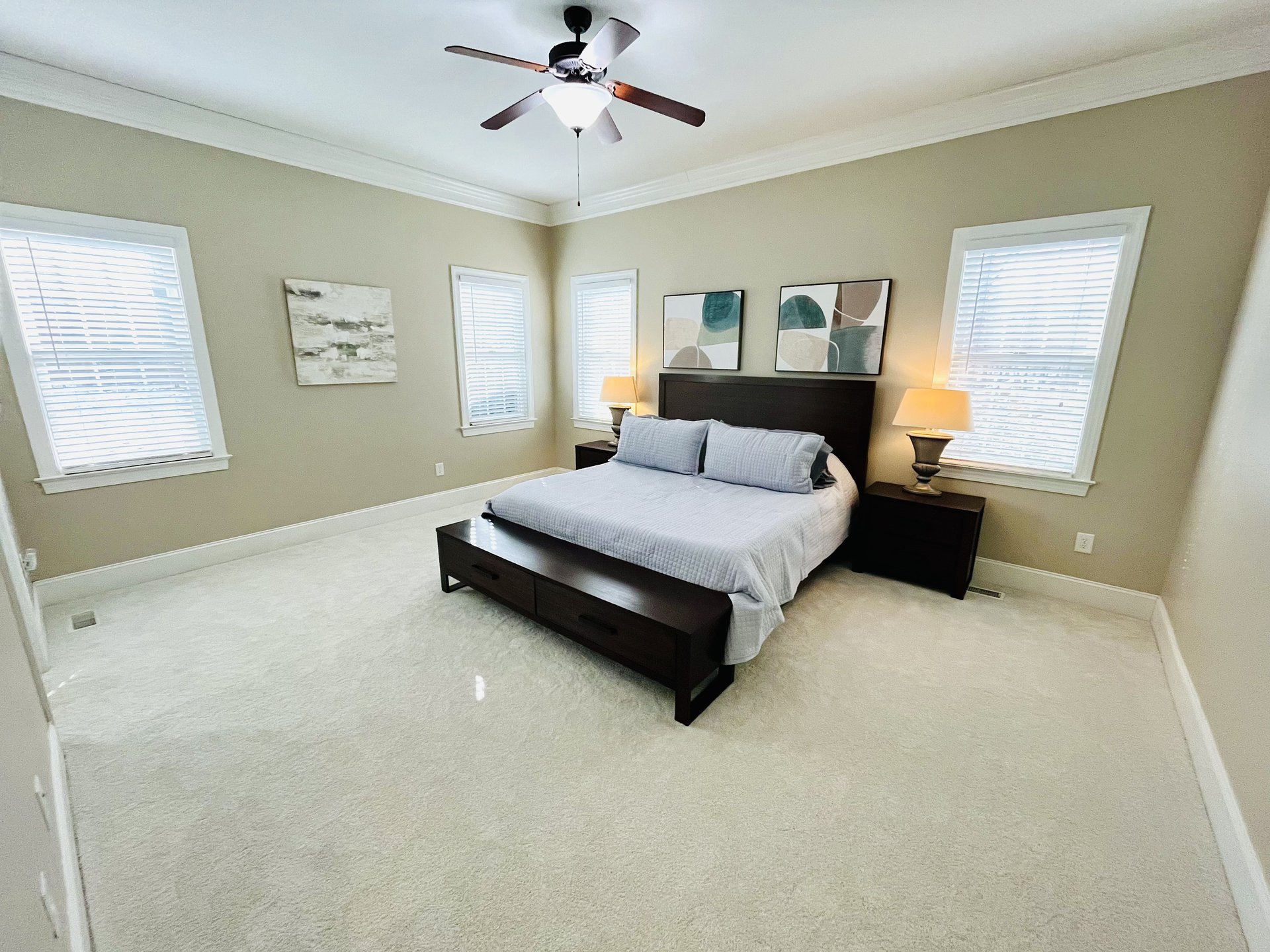Primary Suite king bed with dual lamps and four windows