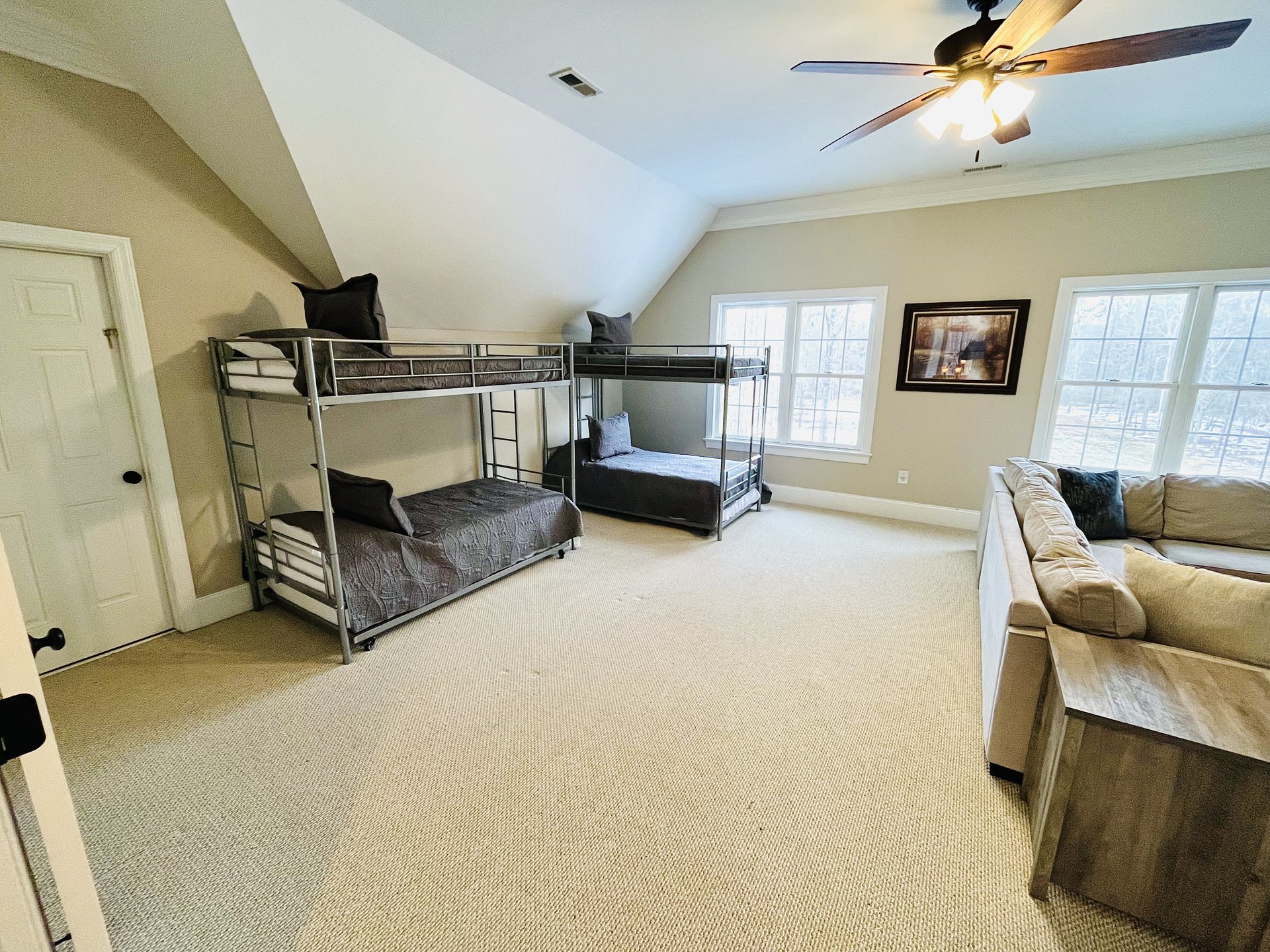 Bunk room showing two bunk sets and sectional seating
