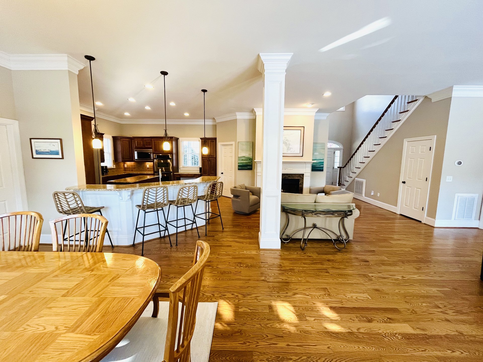 Dining with chandelier and kitchen beyond