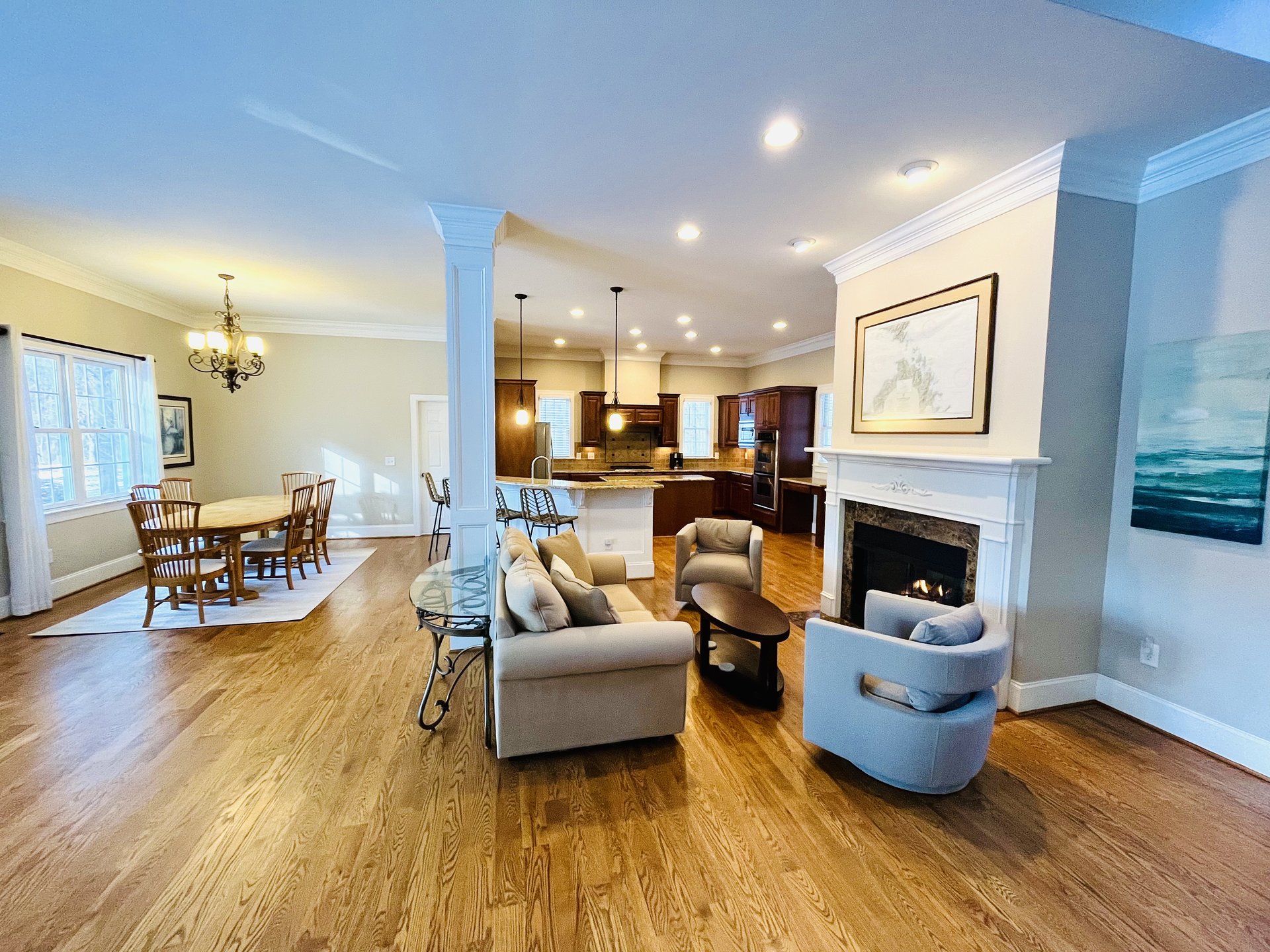 Grand staircase hallway with hardwood floors