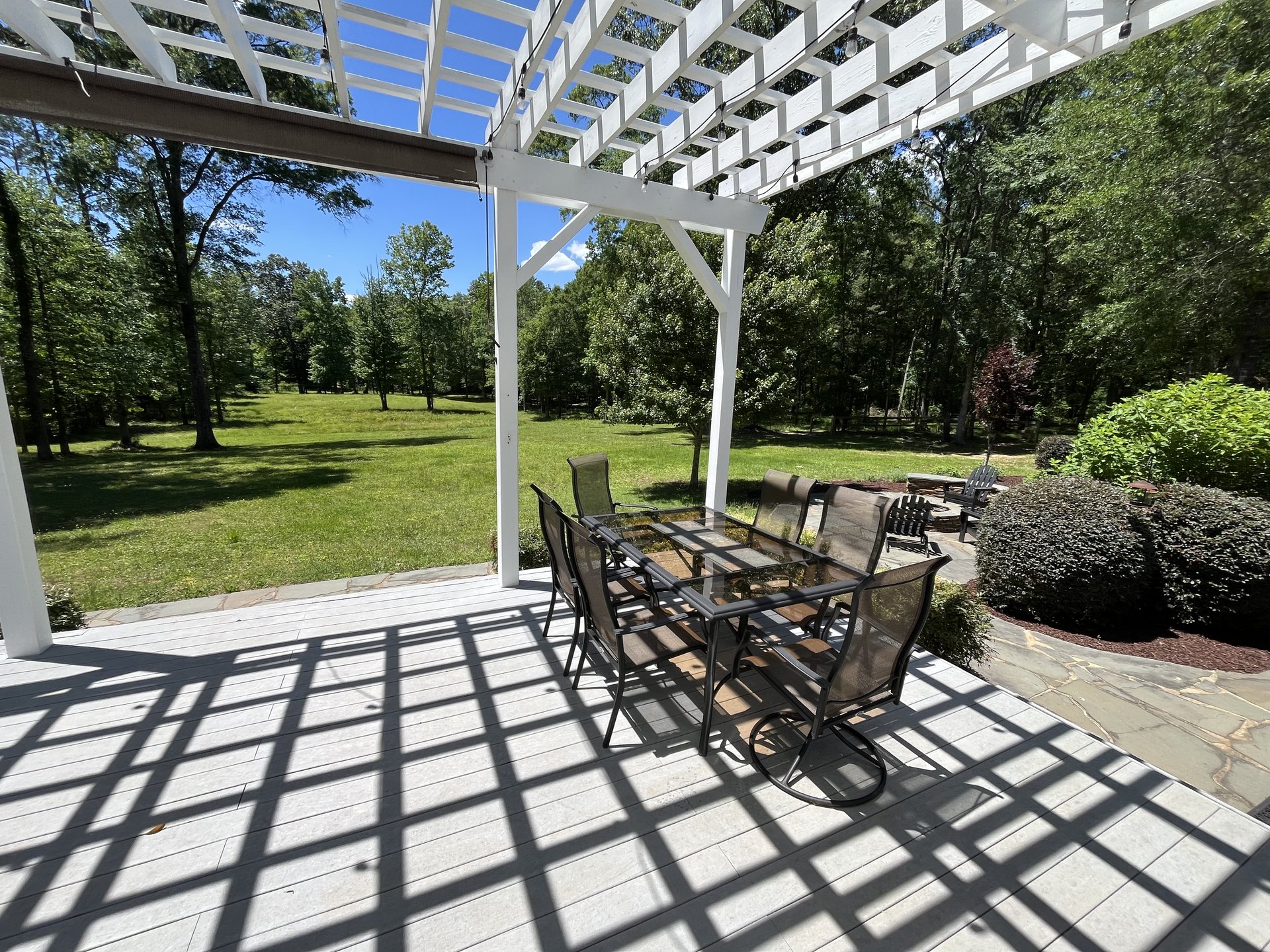 Pergola dining table looking out to grounds